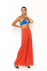 Sommer Swim model facing sideways to the right and wearing Calvi Lounge pant in Campari