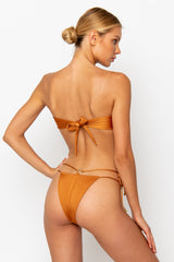 Sommer Swim model facing backwards and wearing a Cece Bandeau bikini top in Papagayo