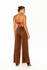 Sommer Swim model facing backwards and wearing Calvi Lounge pant in Campari