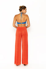 Sommer Swim model facing backwards and wearing Calvi Lounge pant in Campari