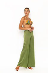 Sommer Swim model facing sideways to the left and wearing Calvi Lounge pant in Campari