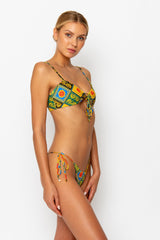 Sommer Swim model facing sideways to the left and wearing a Cara brazilian bikini bottom in Baroque