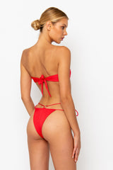Sommer Swim model facing backwards and wearing a Cece bandeau bikini top in Venere